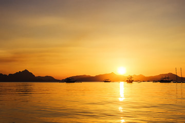 Fototapeta premium Sunset at the sea. Philippine boats at sea, Boracay, El Nido, Philippines