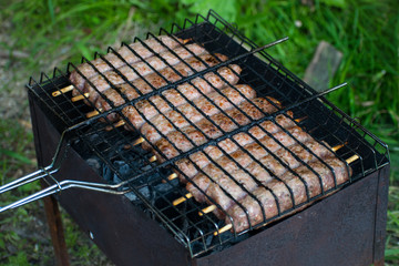 Lulya kebab from meat are prepared in the grill. Shish kebab in the grill.