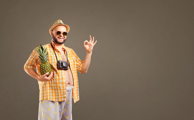 Funny fat man in hat with pineapple smiling in summer on background for text.