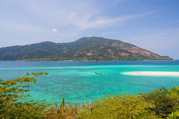 White sand beach beach and long tail boat is floating on sea at ocean in Tropicana located at south of thailand 