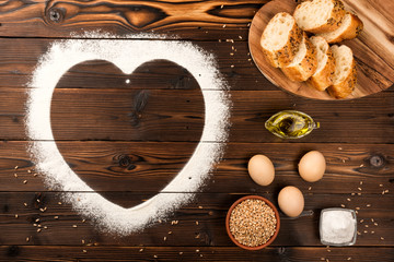 Ingredients of a bakery on a wooden background