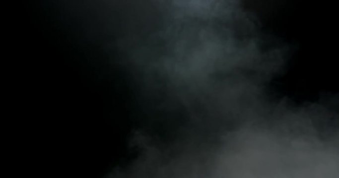 Medium shot of subtle hazy smoke against black shot in studio
