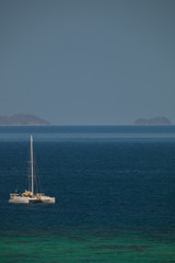 Fototapeta premium Yacht anchored in opening sea from bird eye view
