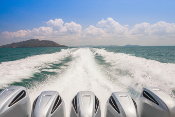 Speed boat engine driving along waving water 