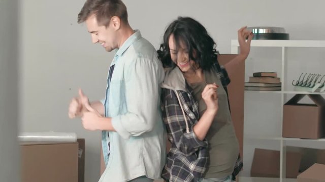 Young couple man and pregnant woman dancing