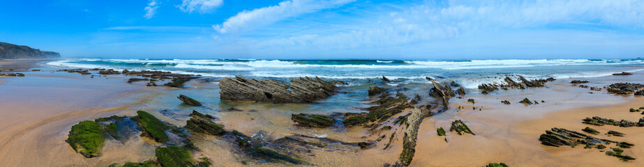 Rock formations on sandy beach (Portugal).