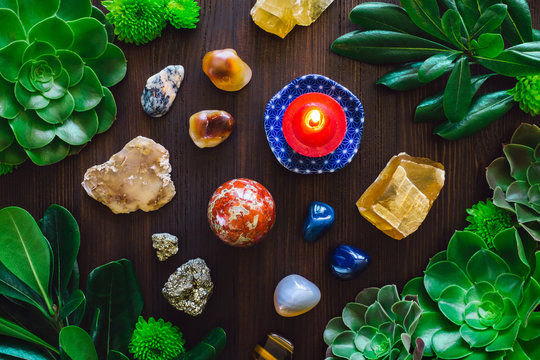 Mixed Stones and Red Candle within Botanical Frame