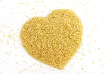 heart-shaped of Sugar from sugar cane top view, Background granulated sugar yellow brown, Sucrose sugar, Red sugar
