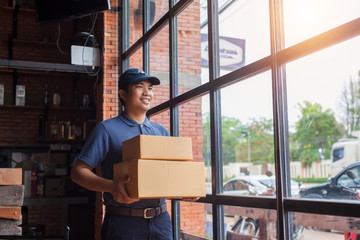 Asia delivery man are holding a cardboard box delivery to his customer.Delivery man are checking to his customer,The seller prepares the delivery box for the customer, online sales, or ecommerce.