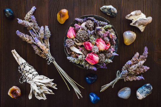 Dried Herbs with Mixed Agate on Dark Wood Table
