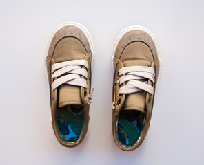 Small boys boots on white background. Pair of kids walk shoes.