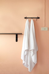 Fototapeta premium towel, a towel hangs on an orange wall (selective focus)