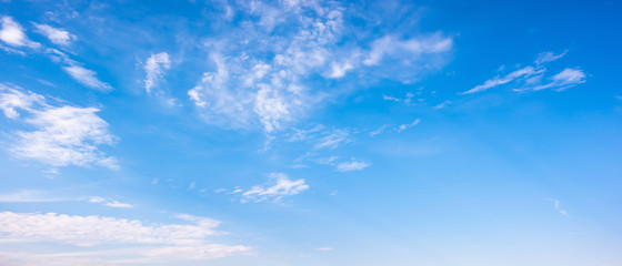 Clouds on a blue sky as a background - obrazy, fototapety, plakaty