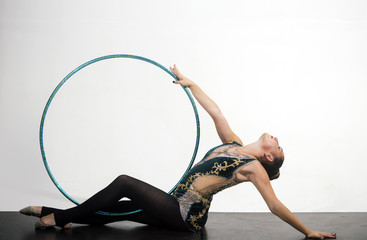 Fototapeta na wymiar acrobatics with hula hoop of prety woman. acrobatics skills of cute girl on white background.