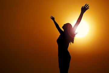 free and happy woman raises her arms to heaven. Have a positive mindset.