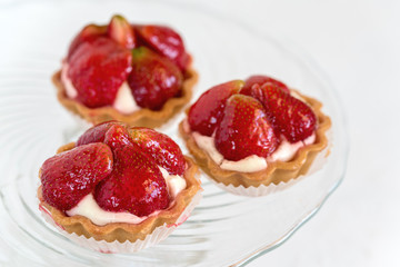Tartlets with strawberries and cream. Dessert with fresh fruits.