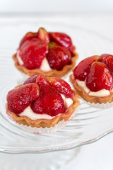 Tartlets with strawberries and cream. Dessert with fresh fruits.