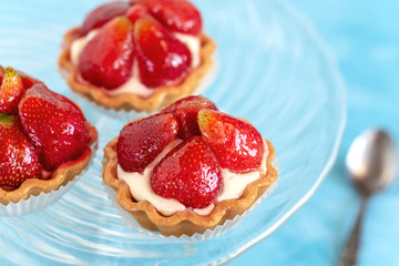 Tartlets with strawberries and cream. Dessert with fresh fruits.