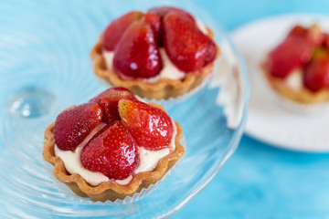 Tartlets with strawberries and cream. Dessert with fresh fruits.