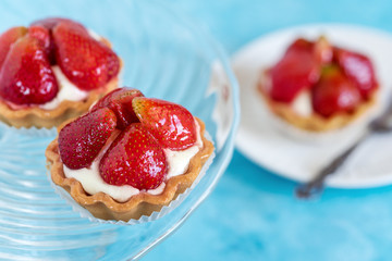 Tartlets with strawberries and cream. Dessert with fresh fruits.