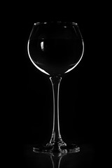 Wine glass on a black background in contrasting light