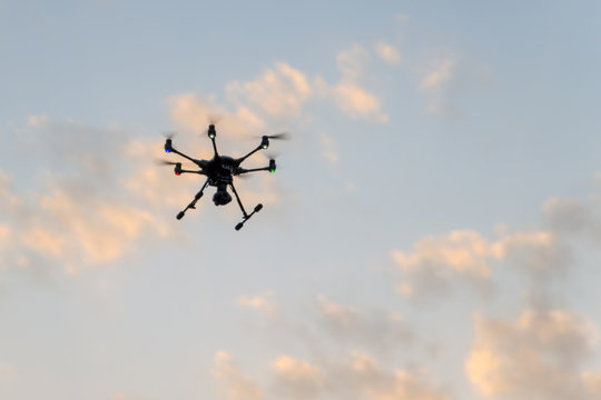 drone in the air at sunset makes photo and video of the surrounding area.