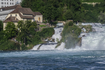 Fototapeta na wymiar View of a powerful waterfall on the River Rhine in Switzerland, the beauty of Europe.
