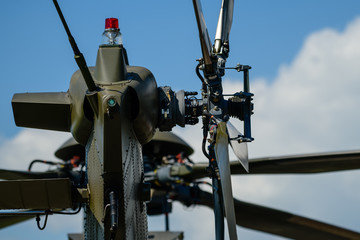 Detail of tail rotor of military helicopter, main rotor in background