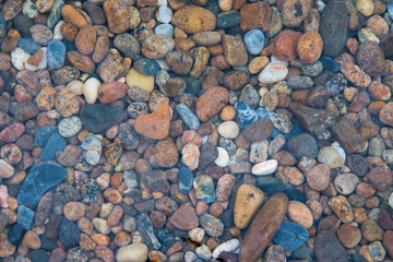Colorful stones under the clear transparent water of Lake Baikal, Russia.