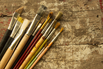 different size of artist paint brushes on a rustic wood table