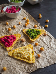 Colored chickpeas puree and nachos chips. 