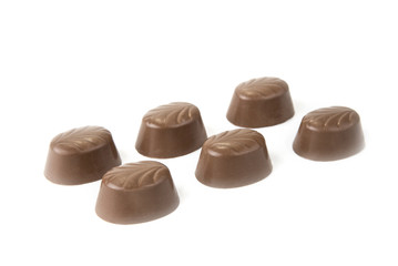 Delicious chocolate pralines on the white. Sweet candy