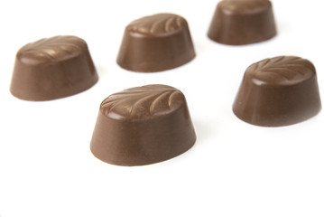 Delicious chocolate pralines on the white. Sweet candy