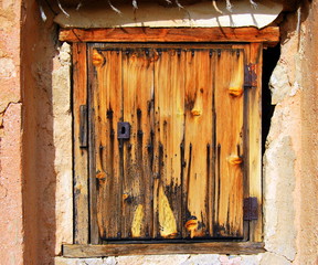 Old door, with yellow paint and rusty lock
