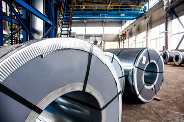 Manufacture of galvanized steel by rolling. Galvanized steel passes through coils. Roll of galvanized steel or metal on machine in industrial workshop on rolling mill, manufacturing metalwork factory