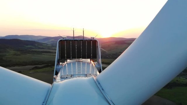 close up view of wind turbine details over beautiful sunset on background aerial shooting forestry landscape on background village area sunny sky windmill farm electricity new technology healthy eco