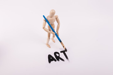 Art painted on white canvas by wood mannequin doll