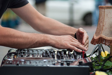 Fototapeta na wymiar closeup of hands of mixer at dance floor in outdoor