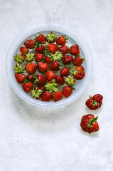 Strawberries in a bowl in the water.Top view