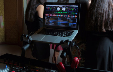 Party dj audio equipment on scene in club.Bright concert lighting.Disc jockey plays music show,mix...