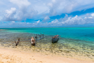 Fototapeta na wymiar Two Outrigger Canoes on a Fiji Beach