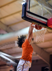Athletic High School Basketball Player Making a Slam Dunk