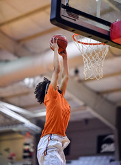 Athletic High School Basketball Player Making a Slam Dunk