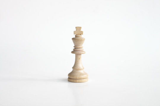 White king chess piece in white isolated background