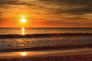 Fototapeta na wymiar Fiery Orange Beach Sunset