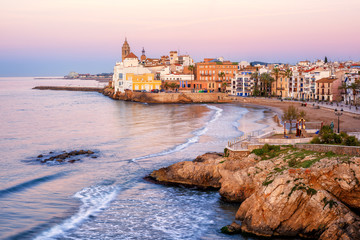 Sand beach and historical Old Town in mediterranean resort Sitges, Spain - obrazy, fototapety, plakaty