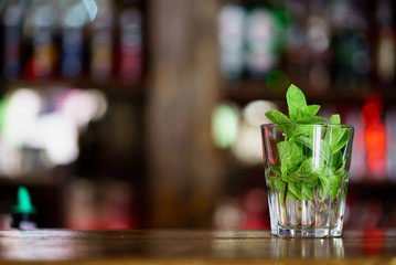Green fresh mint leaves in a glass beaker with water. Detox water