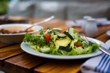 Salad on table in outdoor setting. 