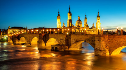 Fototapeta na wymiar Zaragoza city, Spain, bridge and Cathedral del Pilar at sunset