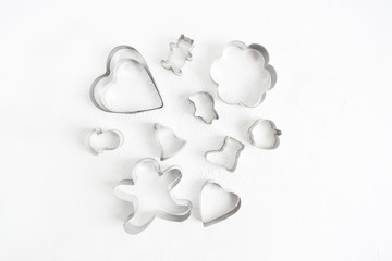 Set of baking cutters for cookies over white texture background with copy space